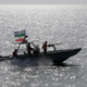 FILE- In this Monday, July 2, 2012 file photo, an Iranian Revolutionary Guard speedboat escorts a passenger ship, unseen, near the spot where an Iranian airliner was shot down by a U.S. warship 24 years ago killing 290 passengers. The U.S. Navy again has accused Iranian patrol boats of harassing an American warship in the Persian Gulf, this time with one Iranian Revolutionary Guard vessel stopping right in front of the USS Firebolt and nearly causing a collision. (AP Photo/Vahid Salemi, File)